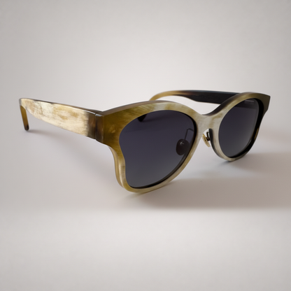 Olivencia ALAIS · EQUINOX handcrafted black and white horn sunglasses in angled view with gradient brown lenses.